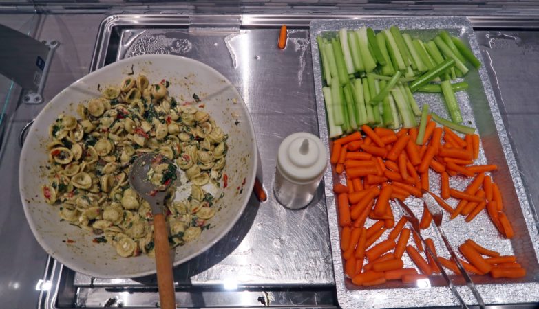 a bowl of pasta and vegetables on a tray
