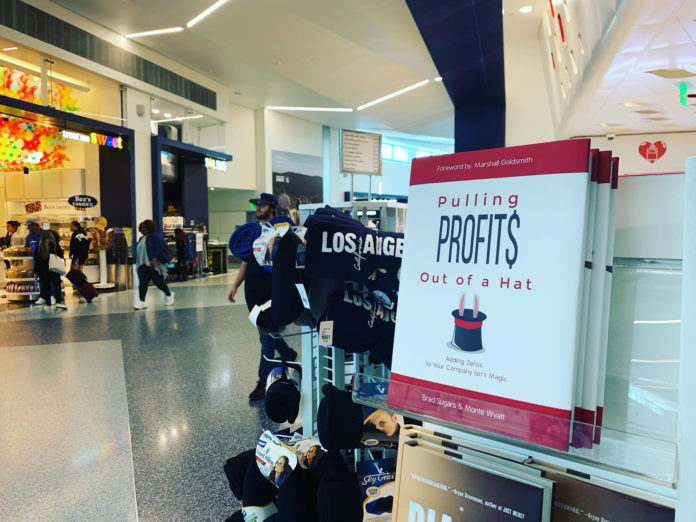 Pulling Profits book in LAX book store