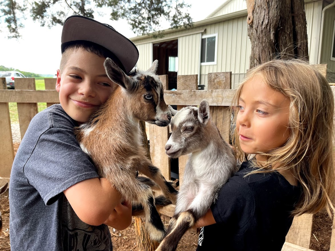 best things to do in Horse Cave Kentucky - Dutch Country Safari Timothy and Scarlett with baby goat 2021-07