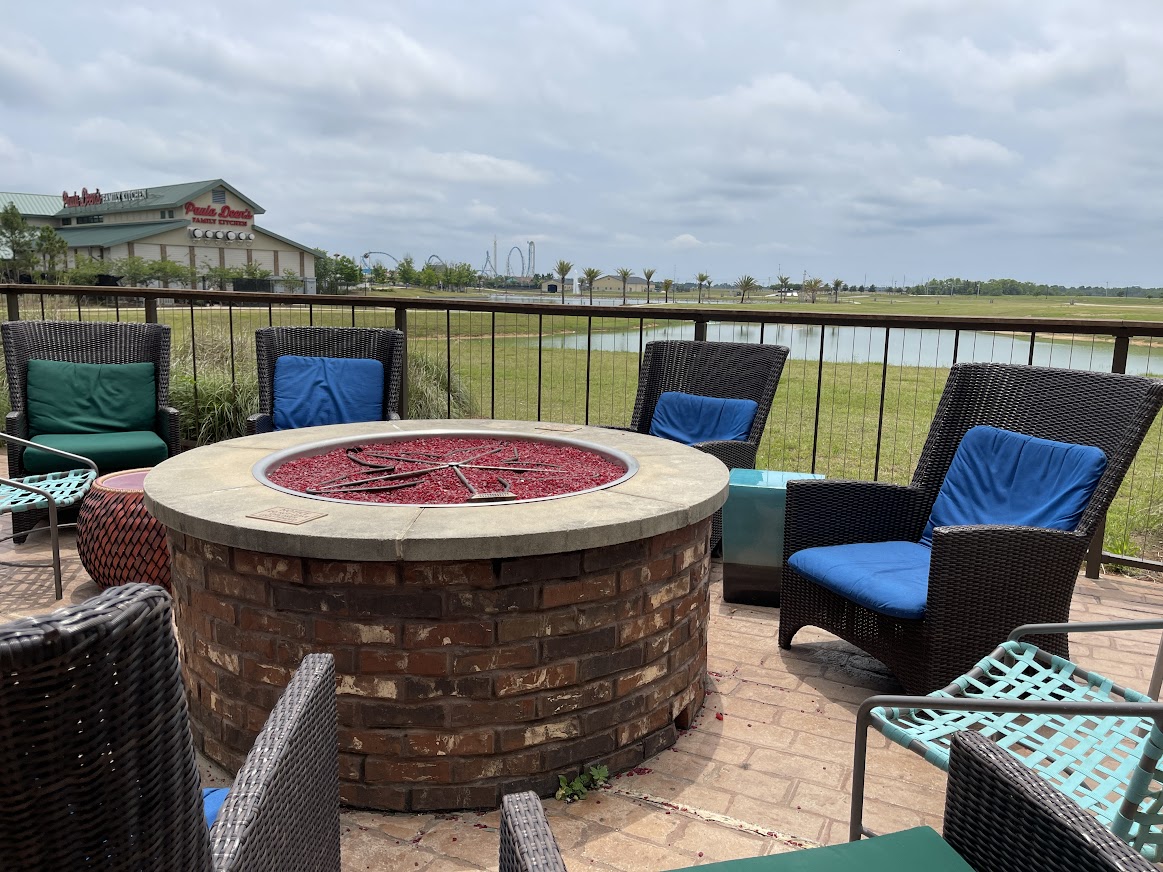 TownePlace Suites Foley at OWA by Marriott May 2023 fireplace overlooking lake
