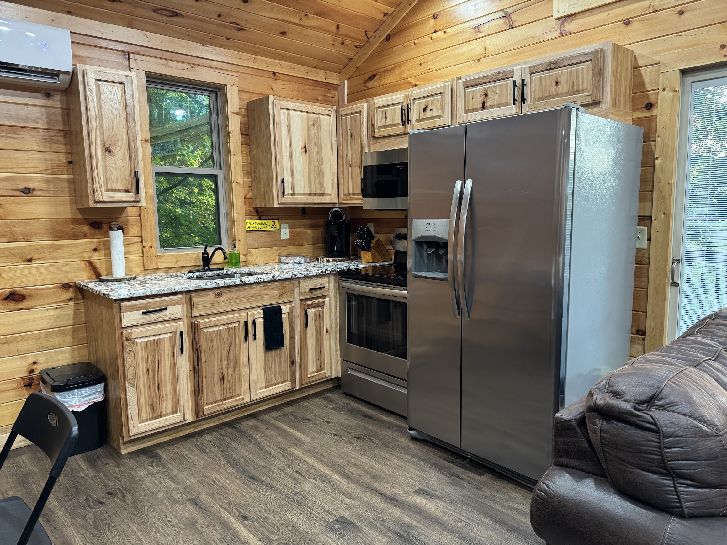 Horse Cave KOA treehouse kitchen with a refrigerator and a wood floor