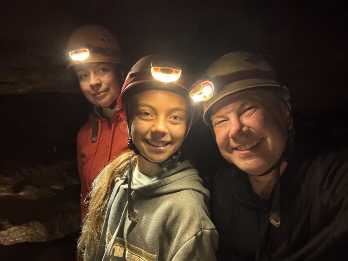 Hidden River Cave off-trail tour hikers with headlamps