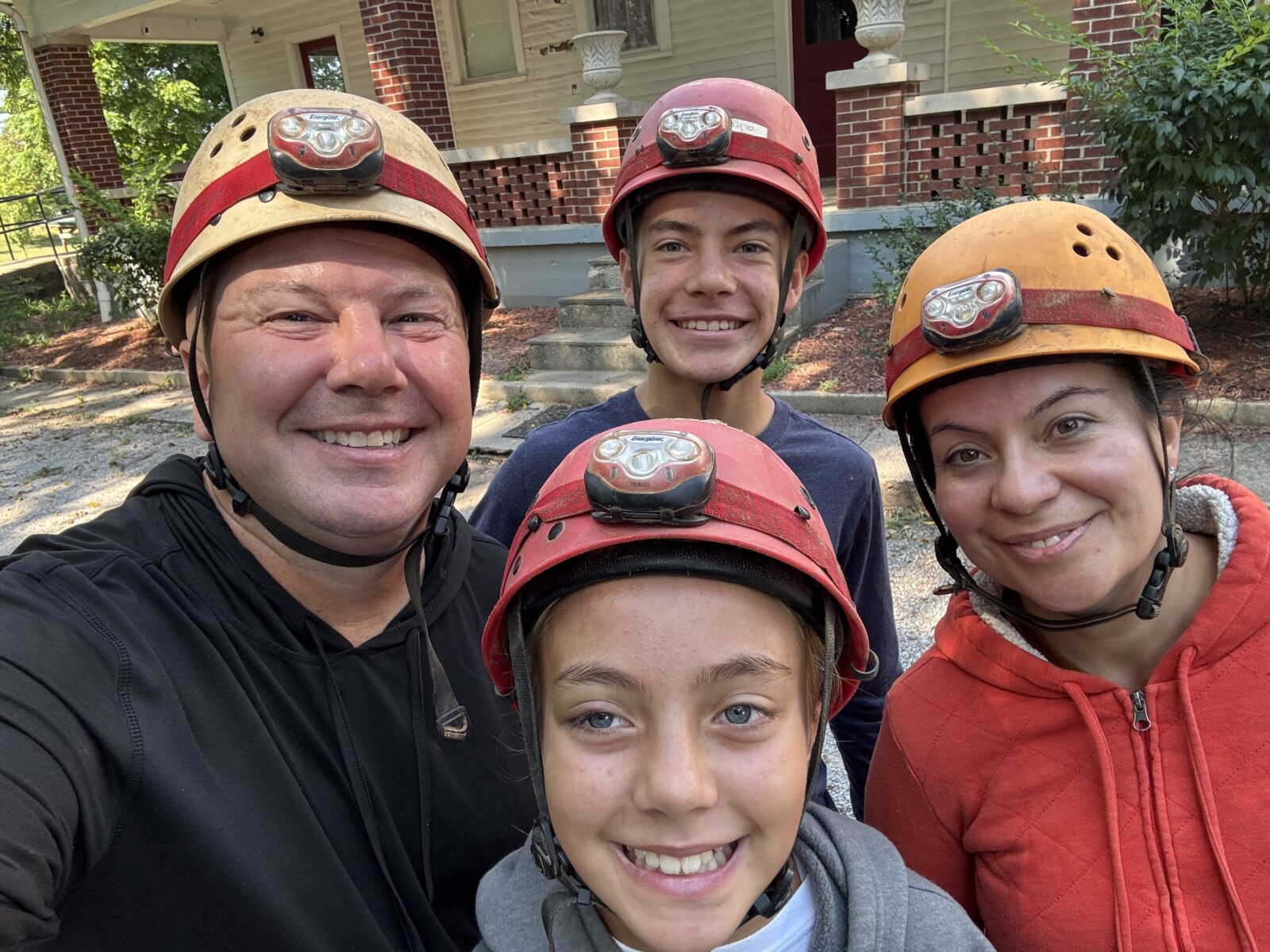 Hidden River Cave off-trail tour family with helmets.